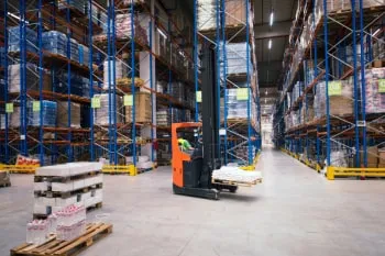 Yüksek raflı bir depoda çalışan forklift