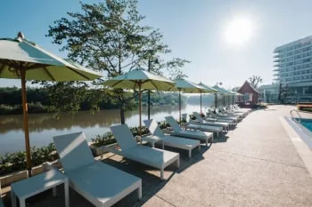 Bir turistik tesisin havuz kenarındaki şezlong ve şemsiyeleri